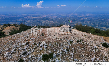 Italian flag waving on the top of a mountain with a breathtaking view 121626695