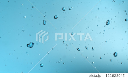 Freeze motion of falling water drops on blue background Freeze motion of falling water drops on blue background 121628045