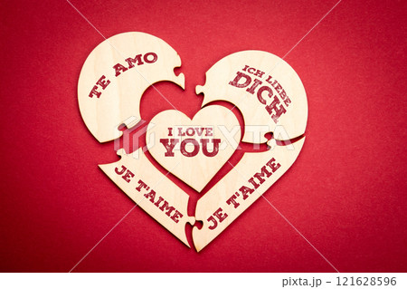 I LOVE YOU. Text in English German Spanish Italian French. Wooden puzzle in the shape of a heart on I LOVE YOU. Text in English German Spanish Italian French. Wooden puzzle in the shape of a heart on 121628596
