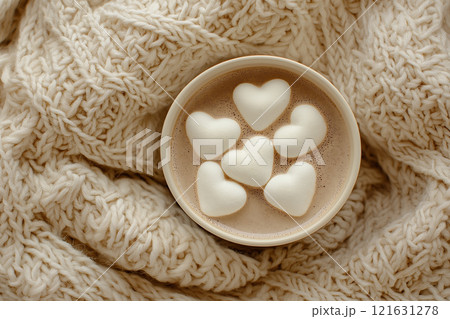 Photorealistic flat lay of heart-shaped marshmallows in cocoa on a knitted blanket 121631278