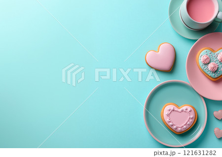 Delightful heart-shaped cookies arranged on pastel plates with a cup of pink beverage 121631282