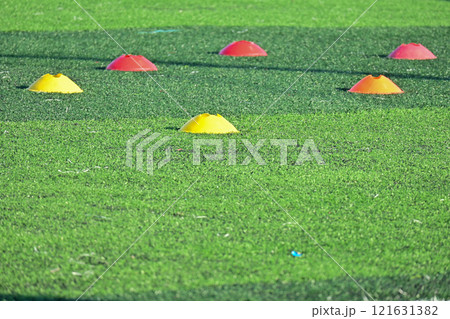 artificial green grass soccer field with training cones 121631382