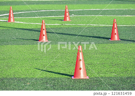 artificial green grass soccer field with orange training cones 121631459