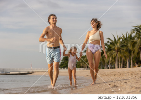 Family happy relaxing on beach children mother father travel summer vacation together sea holiday tropical Sunset time. Trip enjoying bonding. Family day having fun. 121631856