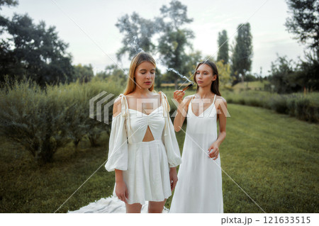 Two women in elegant dresses enjoying nature in...の写真素材 [121633515] - PIXTA