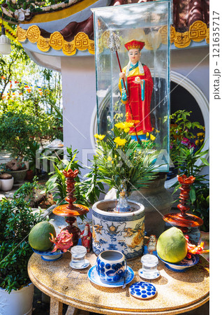 altar with sacred figurines and offerings to gods at a Buddhist pagoda in Vietnam in Asia 121635717