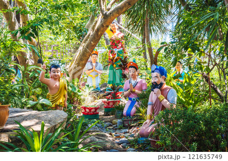 Figures of Asian gods stand on the street on the territory of a Buddhist temple Figures of Asian gods stand on the street on the territory of a Buddhist temple 121635749