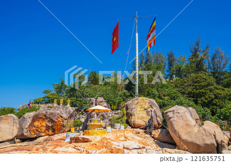 Flagpole with the flag of Vietnam on the island with the Tu ton pagoda on the background of the sea on a clear day 121635751