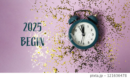 New Year 2025 clock with confetti and festive red bow on pink surface 121636478