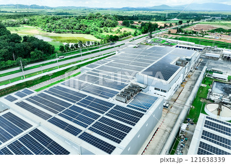 Solar energy for factory and warehouse building. Solar panels on roof of industrial plant. Commercial solar power. Rooftop solar power. Rooftop renewable energy system. Sustainable green energy. 121638339