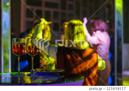 Rooftop party with cocktails and friends dancing 121639517