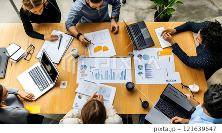 Business team analyzing financial data with charts and laptops 121639647