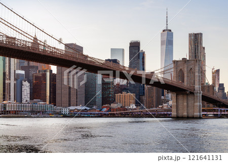 A panoramic sunset view of the Brooklyn Bridge stretching towards Manhattan A panoramic sunset view of the Brooklyn Bridge stretching towards Manhattan 121641131