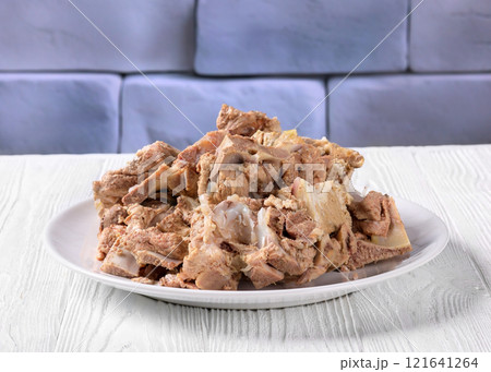 pork and beef bones with leftover meat after cooking broth on a white plate pork and beef bones with leftover meat after cooking broth on a white plate 121641264