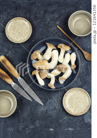 Uncooked champignon mushrooms in a bowl. Uncooked champignon mushrooms in a bowl. 121641356