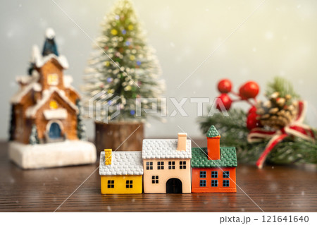 Miniature houses and Christmas trees. Merry Christmas and Happy New Year! Festive preparing for the xmas holidays. Town, city, real estate concept. 121641640