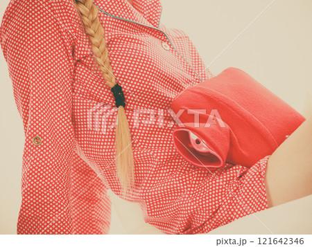 Woman feeling stomach cramps lying on bed Woman feeling stomach cramps lying on bed 121642346