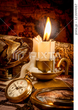 Vintage style travel and adventure. Vintage old compass and other vintage items on the table. 121644087