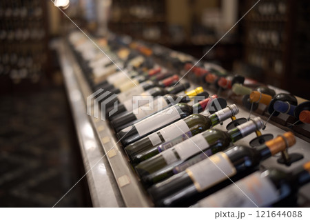 Row of wine bottles with dry red and white wine on wooden. Low depth of field. Row of wine bottles with dry red and white wine on wooden. Low depth of field. 121644088