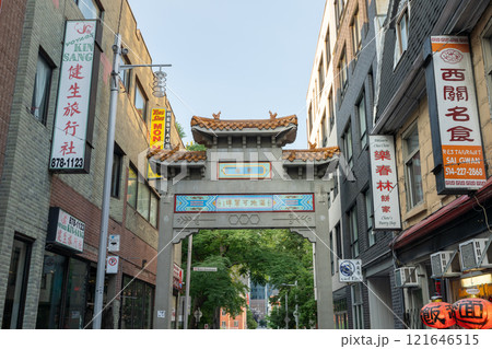 Montreal, Quebec, Canada - August 11 2021 : Street view of Montreal's Chinatown. Paifang Gate of Chinatown on De la Gauchetiere Street. Montreal, Quebec, Canada - August 11 2021 : Street view of Montreal's Chinatown. Paifang Gate of Chinatown on De la Gauchetiere Street. 121646515