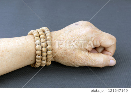 Wooden brown prayer beads bracelet worn on the wrists of elderly people. Wooden brown prayer beads bracelet worn on the wrists of elderly people. 121647149