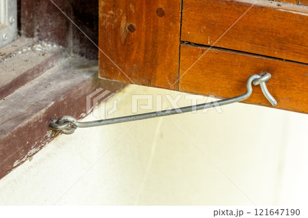 Wooden windows held together with metal window hooks. 121647190