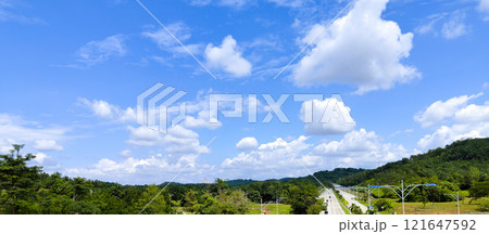 Scenic Countryside Road Under Blue Sky Scenic Countryside Road Under Blue Sky 121647592