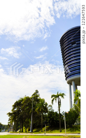 Modern Building with Palm Trees Under Blue Sky Modern Building with Palm Trees Under Blue Sky 121647593