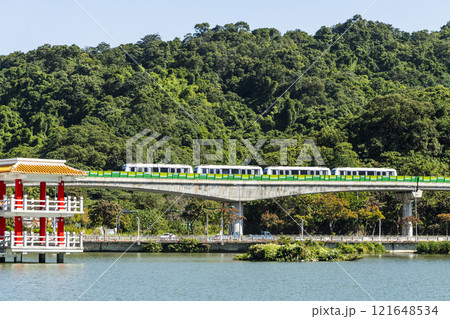 A train traveling on the Wenhu or Brown Line of the Taipei MRT, Taiwan, passes by Taipei Dahu Park. A train traveling on the Wenhu or Brown Line of the Taipei MRT, Taiwan, passes by Taipei Dahu Park. 121648534