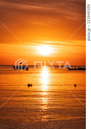 Beautiful red and orange sunrise over the sea. Beautiful red and orange sunrise over the sea. 121649109