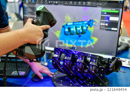 Portable 3D car-shaped handheld scanner is scanning to measure size and texture for future product development production in the automotive industry 121649454