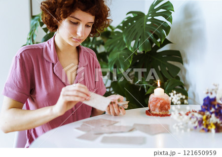 woman telling fortunes with cards woman telling fortunes with cards 121650959