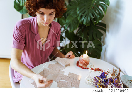 woman telling fortunes with cards woman telling fortunes with cards 121650960