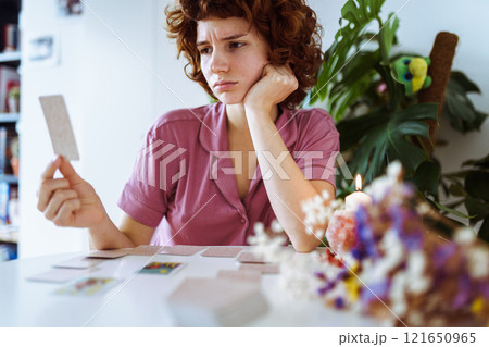 woman telling fortunes with cards woman telling fortunes with cards 121650965
