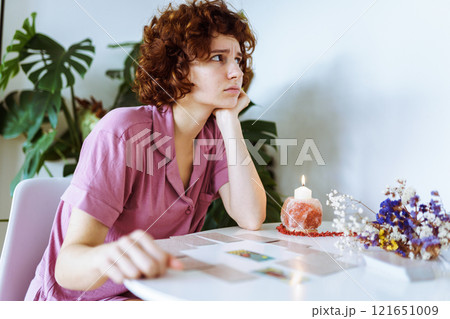 woman telling fortunes with cards woman telling fortunes with cards 121651009