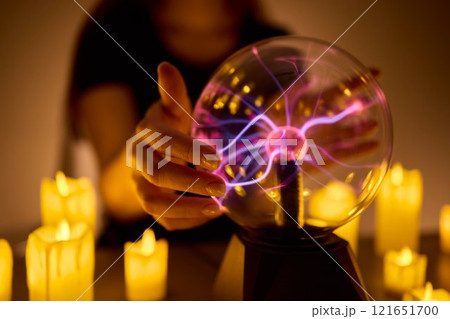 Experience a Mystical Scene with an Energy Ball and Candles, evoking Spiritual Vibes 121651700