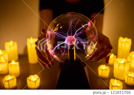 Experience a Mystical Scene with an Energy Ball and Candles, evoking Spiritual Vibes 121651708