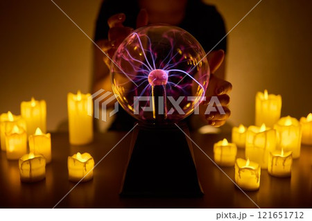 Experience a Mystical Scene with an Energy Ball and Candles, evoking Spiritual Vibes Experience a Mystical Scene with an Energy Ball and Candles, evoking Spiritual Vibes 121651712