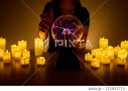 Experience a Mystical Scene with an Energy Ball and Candles, evoking Spiritual Vibes 121651713