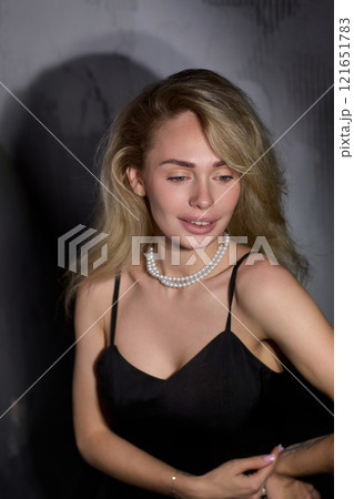 An Elegant Woman in a Beautiful Black Dress Posing Elegantly with Grace and Charm An Elegant Woman in a Beautiful Black Dress Posing Elegantly with Grace and Charm 121651783