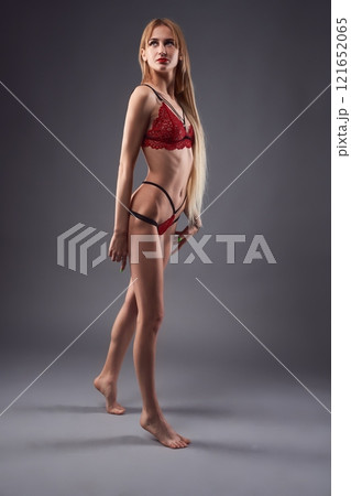 Slim woman in red underwear 121652065