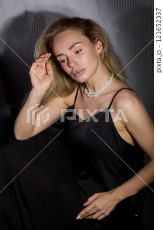An Elegant Woman in a Beautiful Black Dress Posing Elegantly with Grace and Charm 121652337