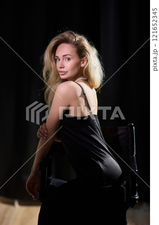 An Elegant Woman in a Beautiful Black Dress Posing Elegantly with Grace and Charm An Elegant Woman in a Beautiful Black Dress Posing Elegantly with Grace and Charm 121652345