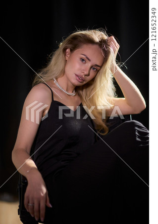 An Elegant Woman in a Beautiful Black Dress Posing Elegantly with Grace and Charm 121652349