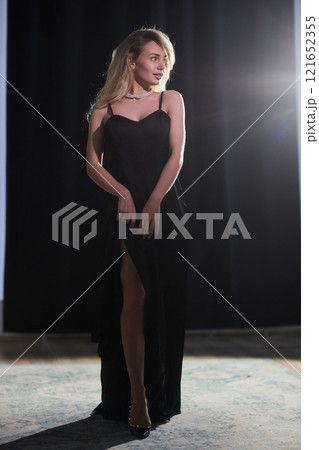 An Elegant Woman in a Beautiful Black Dress Posing Elegantly with Grace and Charm An Elegant Woman in a Beautiful Black Dress Posing Elegantly with Grace and Charm 121652355