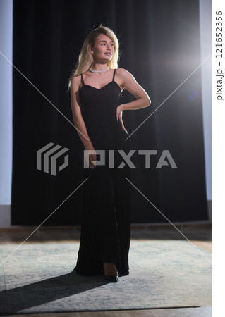 An Elegant Woman in a Beautiful Black Dress Posing Elegantly with Grace and Charm An Elegant Woman in a Beautiful Black Dress Posing Elegantly with Grace and Charm 121652356