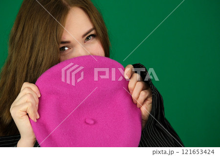 Beautiful you woman in pink dress and pink beret smiling happily Beautiful you woman in pink dress and pink beret smiling happily 121653424