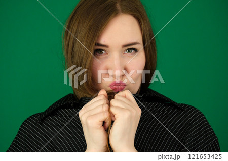 Close-up details of a woman's face. Nose, pursed lips, neck 121653425
