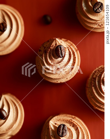 Rich mocha mousse elegantly swirled and topped with a coffee bean, creating a delectable treat against a warm backdrop that enhances its allure Rich mocha mousse elegantly swirled and topped with a coffee bean, creating a delectable treat against a warm backdrop that enhances its allure 121654109