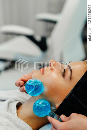Rejuvenating facial treatment with cooling gel balls at a spa Rejuvenating facial treatment with cooling gel balls at a spa 121656263